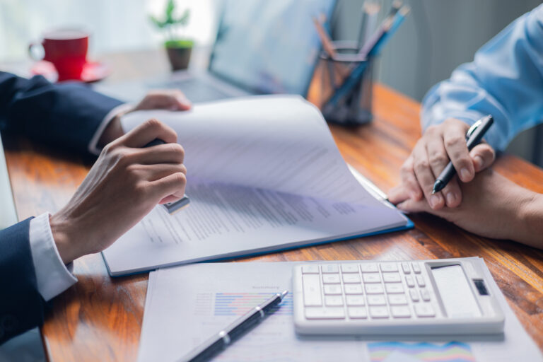 Businesswoman reviewed mortgage document and contract with their client, ensuring loan and credit details were clear, while discussing estate insurance and other finance aspects. finance, credit, pay. Businesswoman reviewed mortgage document and contract with their client, ensuring loan and credit details were clear, while discussing estate insurance and other finance aspects. finance, credit, pay.